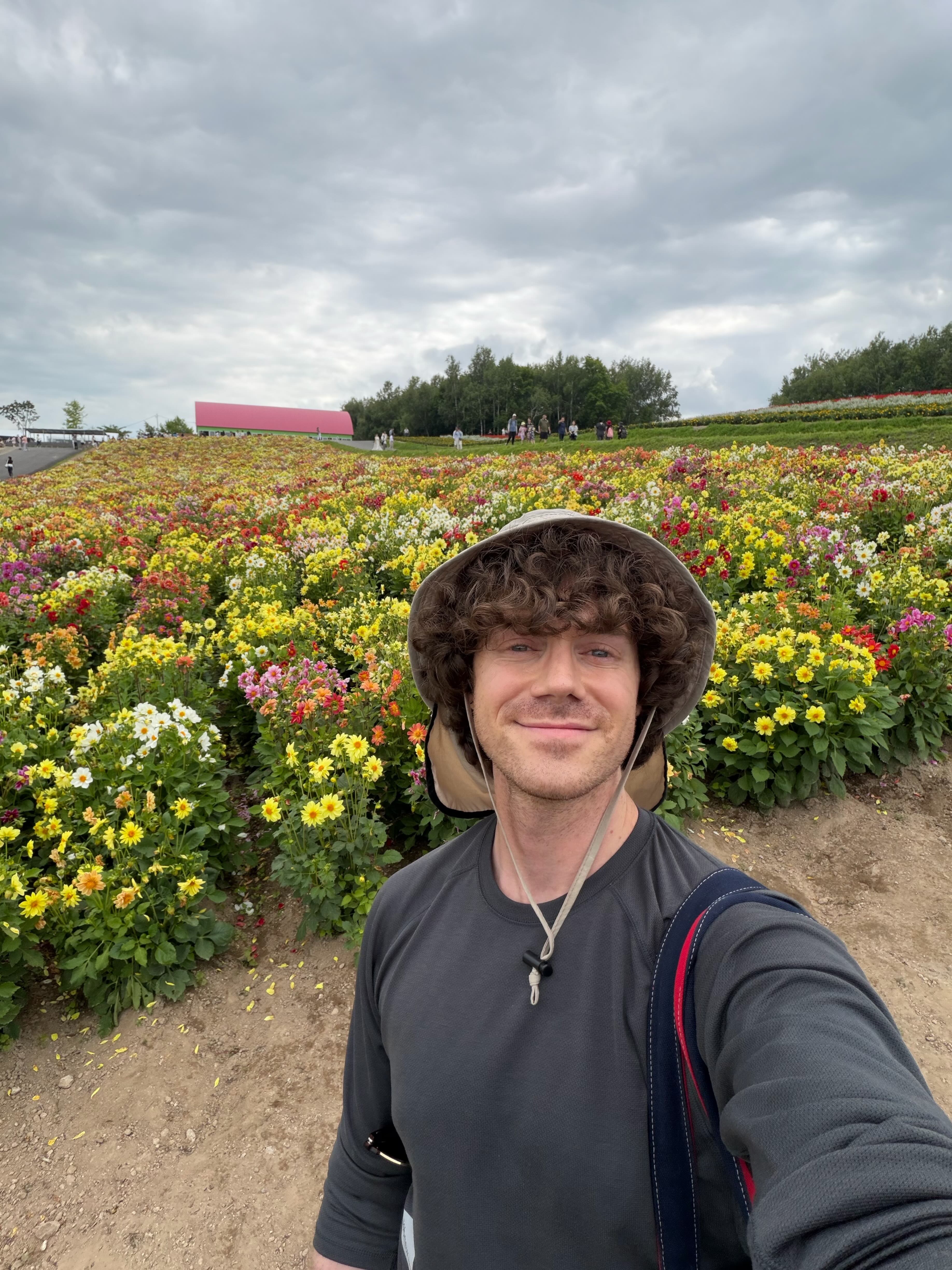 Justin in a hat in a field of flowers